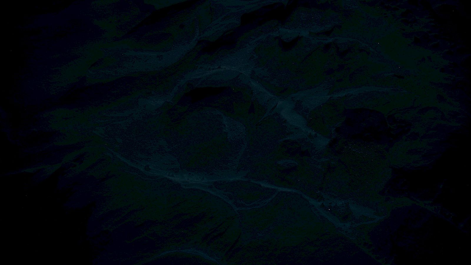 The image is very dark and unclear, showing faint patterns or textures in shades of black and dark blue.