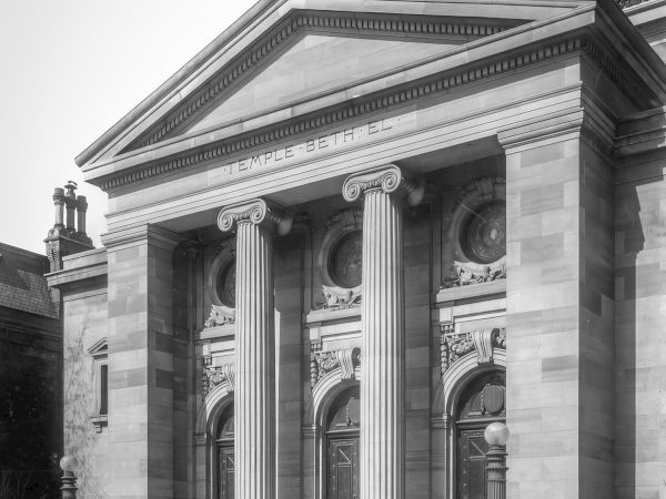The image shows a neoclassical building with columns and ornate details, labeled "Temple Beth El" on the entablature.