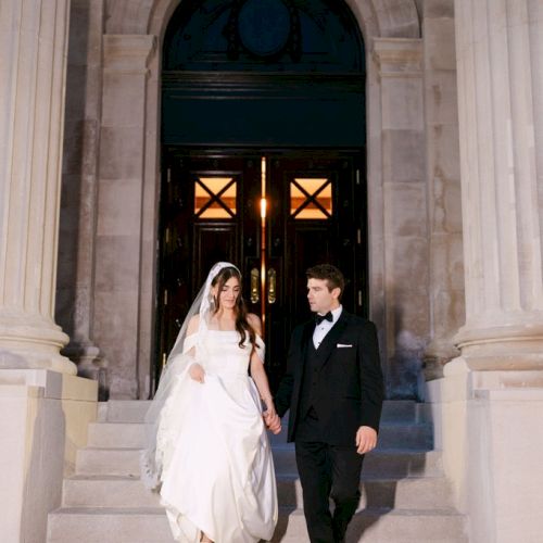 Newly-wedded bride and groom descend the dramatic Bonstelle Playhouse steps.