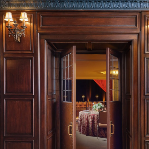 The interior entrances to the Bonstelle theatre boast meticulously restored leaded glass windows, vintage sconces, and rich wood paneling.